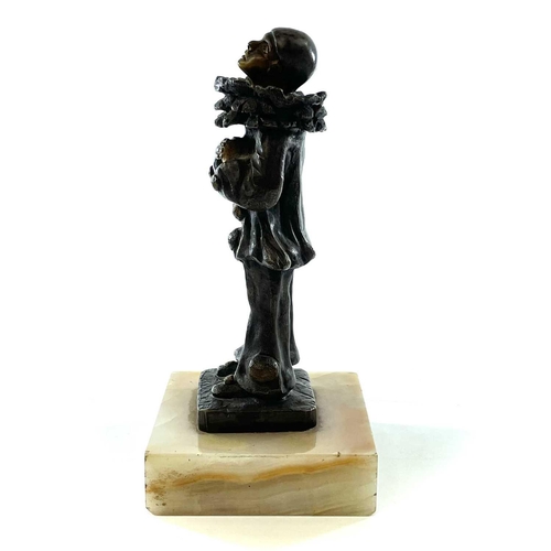 66 - E Benoit, A French Art Deco silvered bronze and gilt figure of Pierrot, on a square onyx base, heigh... 