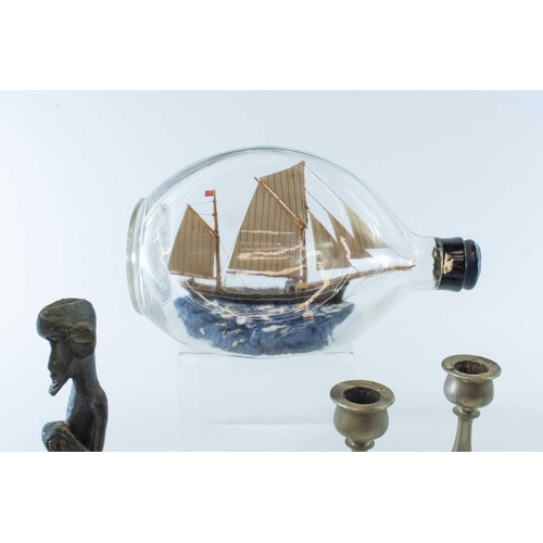 74 - A model of the sailing boat Ceres, in a Dimple bottle, labelled as purchased on a Honeymoon in Salco... 