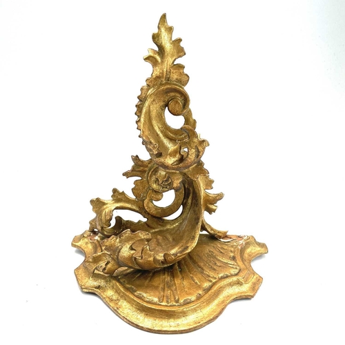 76 - A giltwood carved wall bracket, Florentine, early 20th century, with rococo scroll leafy supports, h... 