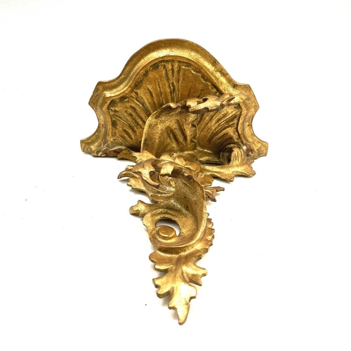 76 - A giltwood carved wall bracket, Florentine, early 20th century, with rococo scroll leafy supports, h... 