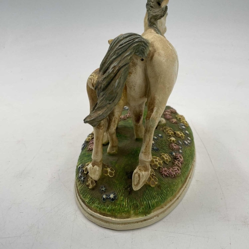 802 - Kate Westrup, A Lamorna pottery mare and foal group, the oval base with applied scattered flowerhead... 