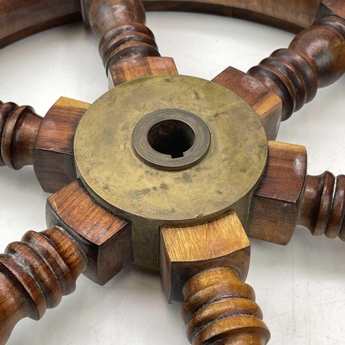 81 - A teak and brass yacht or ship's wheel, mid 20th century, with six turned spokes, diameter 51cm.