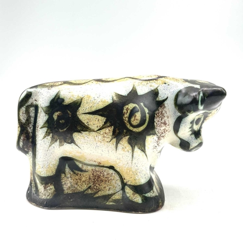 820 - A Celtic, Newlyn pottery bull decorated in the folksy pattern, height 14.5cm length 24cm.