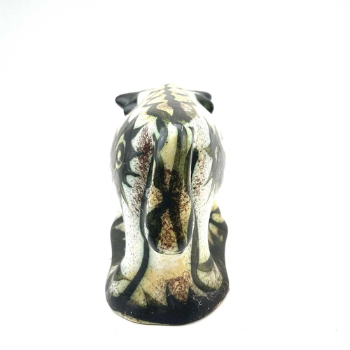 820 - A Celtic, Newlyn pottery bull decorated in the folksy pattern, height 14.5cm length 24cm.