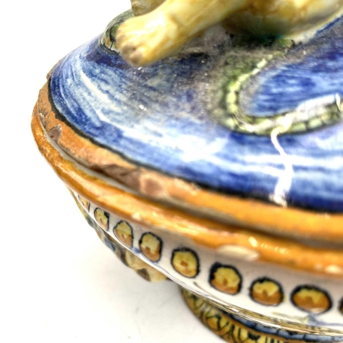 838 - A late 19th century Cantagalli maiolica bowl and cover with eros on a dolphin and twin shell handles... 