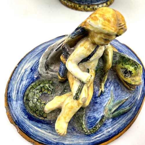 838 - A late 19th century Cantagalli maiolica bowl and cover with eros on a dolphin and twin shell handles... 