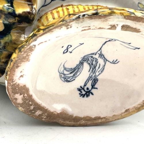 838 - A late 19th century Cantagalli maiolica bowl and cover with eros on a dolphin and twin shell handles... 