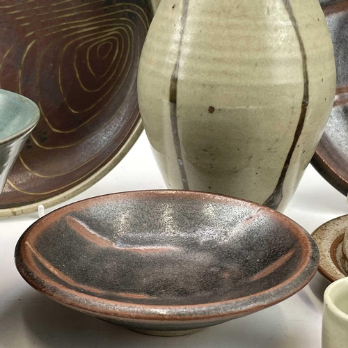 858 - Studio pottery, including a Leach standard ware saucer and dish, a plaque by Frank Hamer, a Lostwith... 