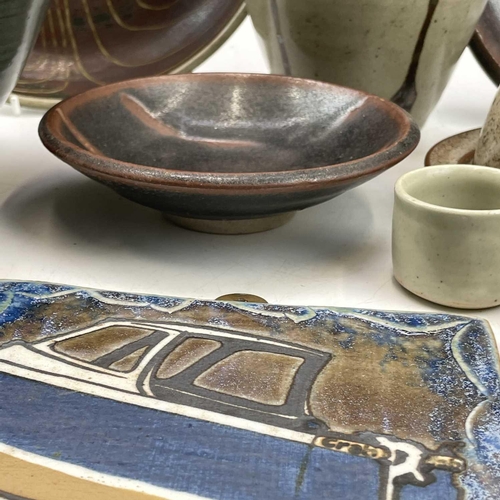 858 - Studio pottery, including a Leach standard ware saucer and dish, a plaque by Frank Hamer, a Lostwith... 