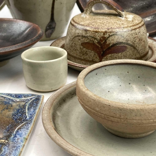 858 - Studio pottery, including a Leach standard ware saucer and dish, a plaque by Frank Hamer, a Lostwith... 