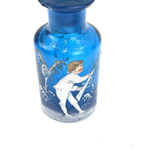 863 - A Mary Gregory enamelled blue glass scent bottle decorated with a boy holding a gun height 9cm toget... 