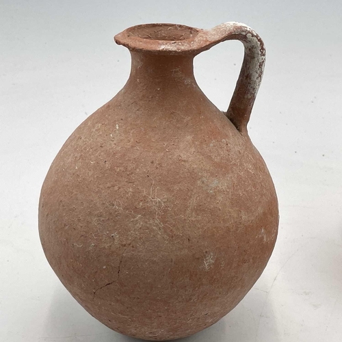 870 - A Pre Columbian style pottery jug in the form of a parrot height 16cm together with two pottery jugs... 