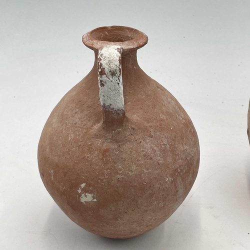 870 - A Pre Columbian style pottery jug in the form of a parrot height 16cm together with two pottery jugs... 