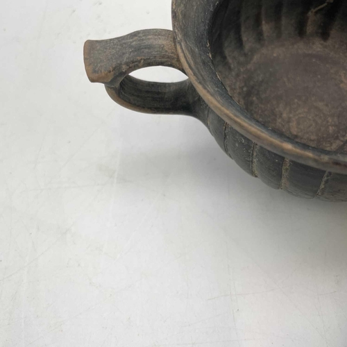 880 - A Hellenistic pottery Kantharos with twin handles and reeded body on a short foot height 6.5cm diame... 