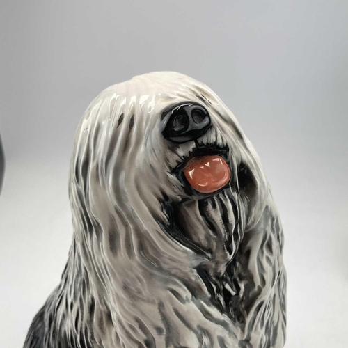 895 - A Beswick fireside advertising figure of the Dulux dog, with its front paw resting on a tin of paint... 