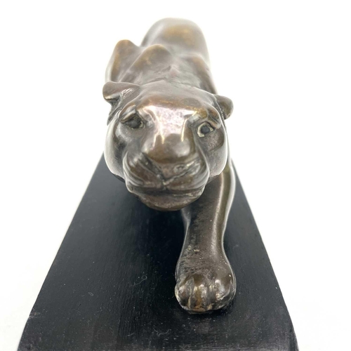 9 - An Art Deco bronze model of a prowling panther, with remnants of plated finish, on an ebonised base,... 