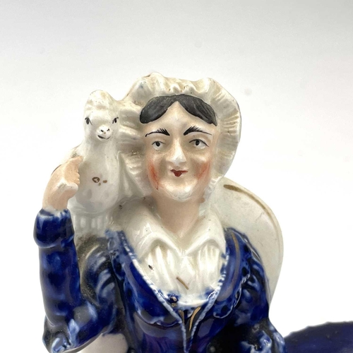 900 - A Rare Victorian Staffordshire figure of a lady with a parrot on her shoulder, the table at her side... 