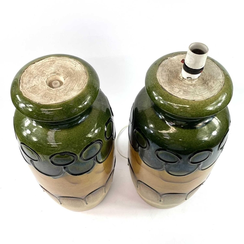 906 - A pair of large West German pottery lamps decorated in yellow and green, height 45cm.