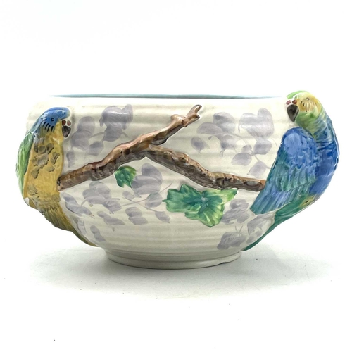 907 - A Clarice Cliff bowl, moulded with two parrots on a branch, diameter 24cm.One parrot with a chipped ... 