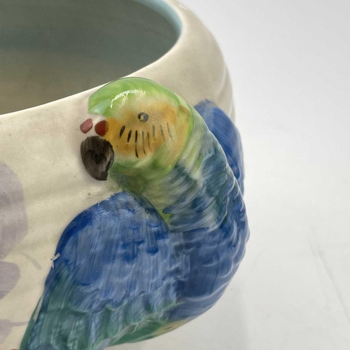 907 - A Clarice Cliff bowl, moulded with two parrots on a branch, diameter 24cm.One parrot with a chipped ... 