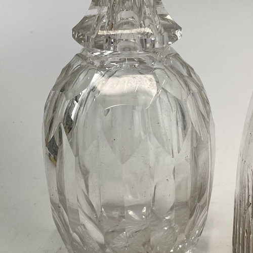 909 - A 19th century cut glass decanter with a later stopper height 25cm together with another two glass d... 