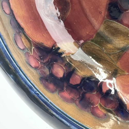 919 - A Moorcroft pomegranate pattern bowl, internally painted with five fruit and berries, impressed mark... 