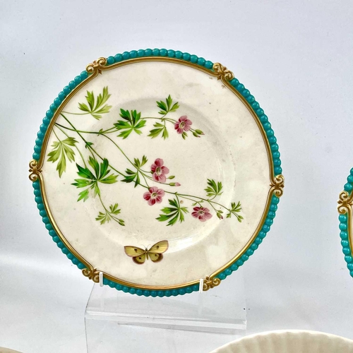 938 - A pair of Victorian porcelain dessert plates, each painted with a flower and a butterfly within gilt... 