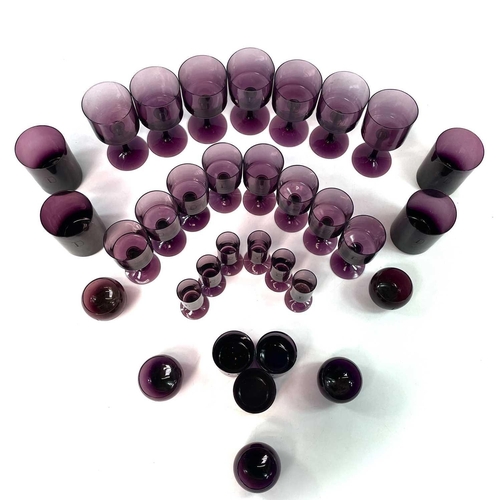 939 - A part suite of amethyst table glassware, mid 20th century, comprising seven red wines, eight white ... 