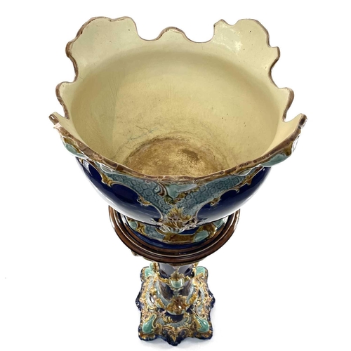 943 - A French Majolica jardiniere and stand, circa 1900, with moulded decoration on a blue ground, height... 