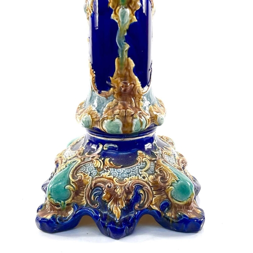 943 - A French Majolica jardiniere and stand, circa 1900, with moulded decoration on a blue ground, height... 