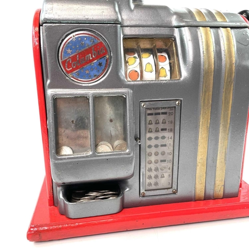 96 - A vintage Columbia table top one armed bandit slot or fruit machine, with later red painted finish, ... 