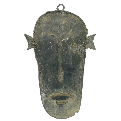 98 - An unusual African Benin type bronze wall mask, with red painted lips, height 32cm.