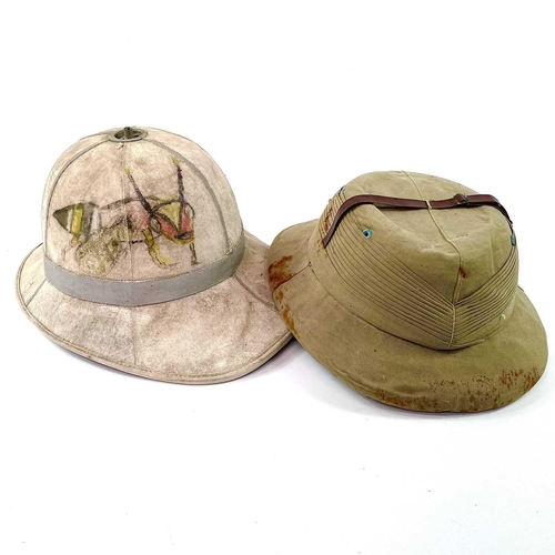 319 - Second World War Era Headwear (x2). A box containing two tropical helmets -probably military - one o... 