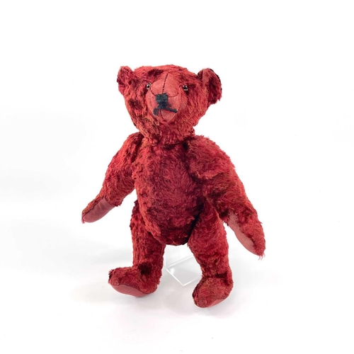 737 - Mid 20th Century Red Plush Teddy Bear. Comprising an articulated plush red bear (length 35cm), possi... 