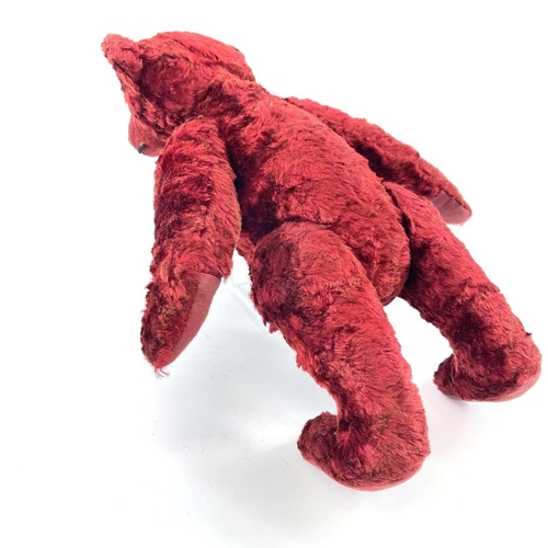 737 - Mid 20th Century Red Plush Teddy Bear. Comprising an articulated plush red bear (length 35cm), possi... 