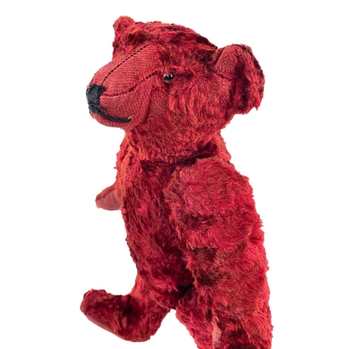 737 - Mid 20th Century Red Plush Teddy Bear. Comprising an articulated plush red bear (length 35cm), possi... 