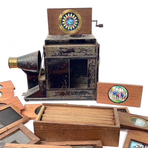 769 - Tinplate Magic Lantern Viewer and Selection of Slides An incomplete tinplate viewer together with a ... 