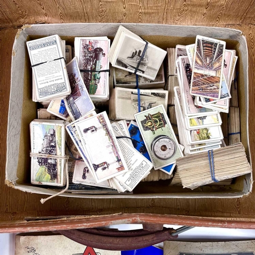 930 - Cigarette Cards An attache case holding a large quantity of cigarette cards contained in tins, a box... 