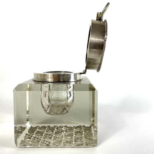 113 - An unusual silver timepiece lidded glass inkwell. By John Grinsell & Sons, the hinged lid revealing ... 