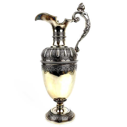 12 - An impressive Victorian silver wine ewer by Sibrey Hall & Co. The handle cast with a caryatid, the b... 