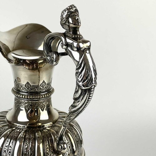 12 - An impressive Victorian silver wine ewer by Sibrey Hall & Co. The handle cast with a caryatid, the b... 