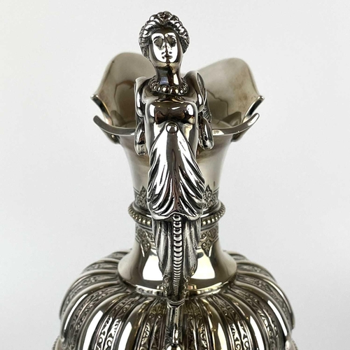 12 - An impressive Victorian silver wine ewer by Sibrey Hall & Co. The handle cast with a caryatid, the b... 