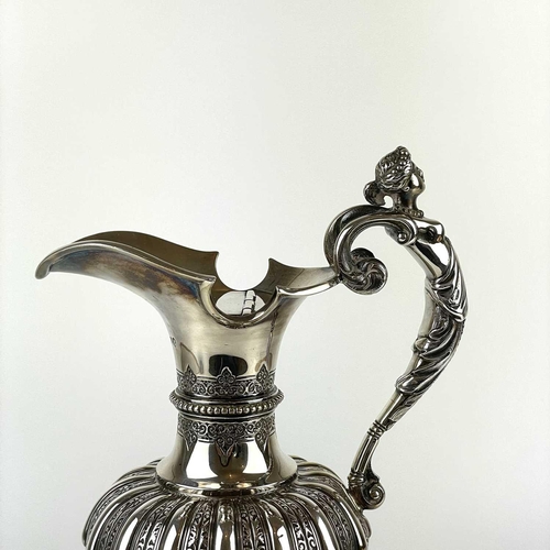 12 - An impressive Victorian silver wine ewer by Sibrey Hall & Co. The handle cast with a caryatid, the b... 