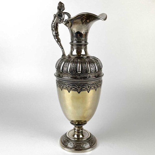 12 - An impressive Victorian silver wine ewer by Sibrey Hall & Co. The handle cast with a caryatid, the b... 