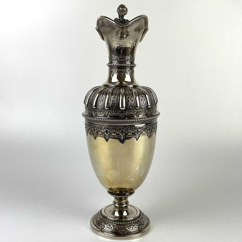 12 - An impressive Victorian silver wine ewer by Sibrey Hall & Co. The handle cast with a caryatid, the b... 