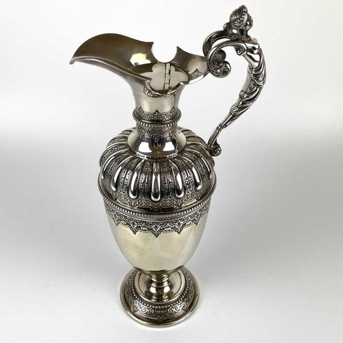 12 - An impressive Victorian silver wine ewer by Sibrey Hall & Co. The handle cast with a caryatid, the b... 