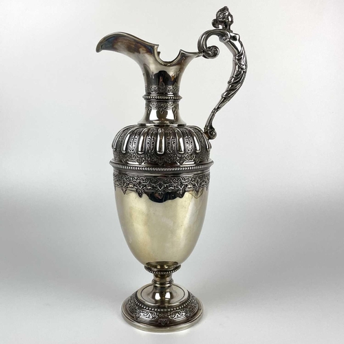 12 - An impressive Victorian silver wine ewer by Sibrey Hall & Co. The handle cast with a caryatid, the b... 