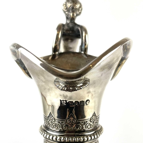 12 - An impressive Victorian silver wine ewer by Sibrey Hall & Co. The handle cast with a caryatid, the b... 