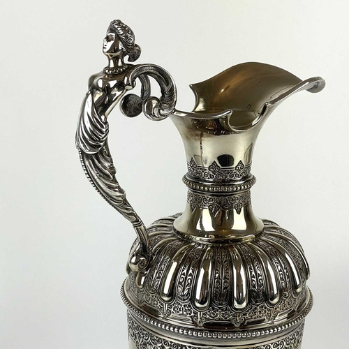 12 - An impressive Victorian silver wine ewer by Sibrey Hall & Co. The handle cast with a caryatid, the b... 