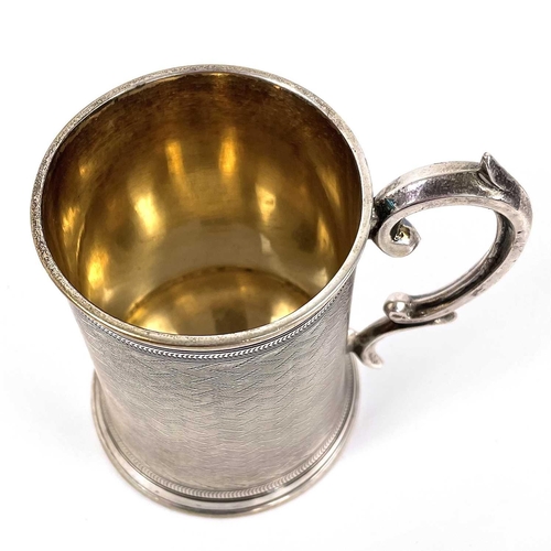 17 - A Victorian silver Christening mug by William Horton. With engine turned decoration and C scroll han... 